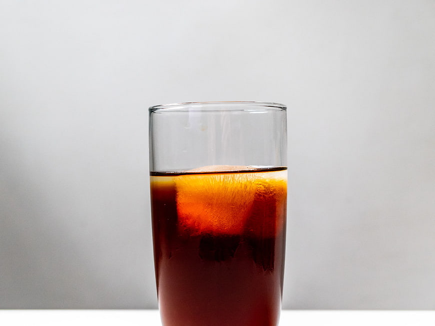 Glass of Cold Brew Coffee with Ice Cube on White Background