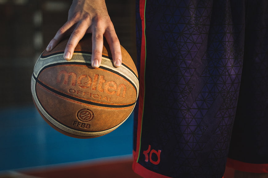 Close-up of basketball player holding Molten ball