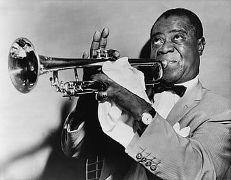Vintage black and white portrait of Louis Armstrong playing trumpet