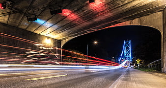 Long Exposure Night Traffic Under Bridge with Blue Lights