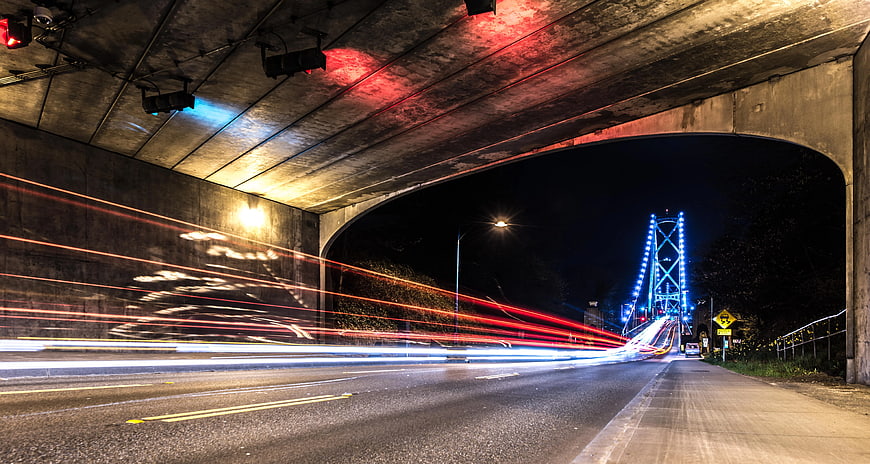Long Exposure Night Traffic Under Bridge with Blue Lights