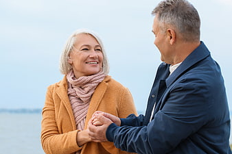 Happy Senior Couple Holding Hands Outdoors