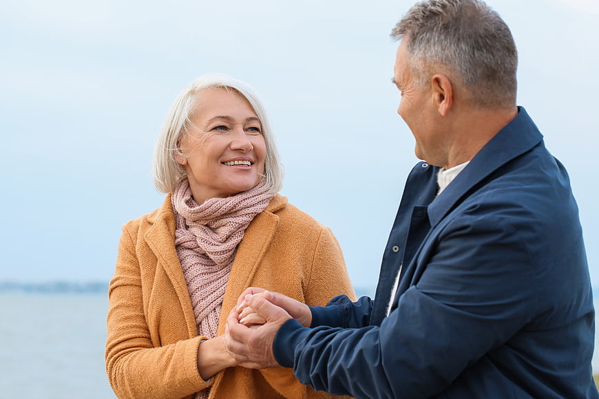 Happy Senior Couple Holding Hands Outdoors