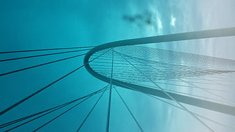Low angle view of modern cable-stayed bridge against blue sky