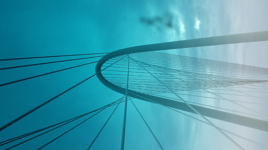 Low angle view of modern cable-stayed bridge against blue sky