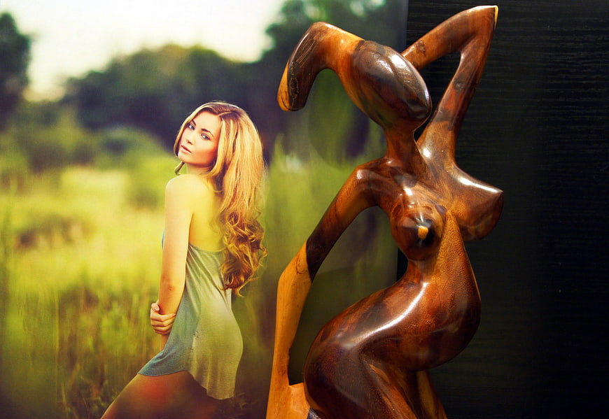 Blonde Woman and Wooden Sculpture in Split Composition