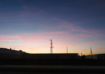 Silhouette of Cell Tower Against Pink and Blue Sunset Sky