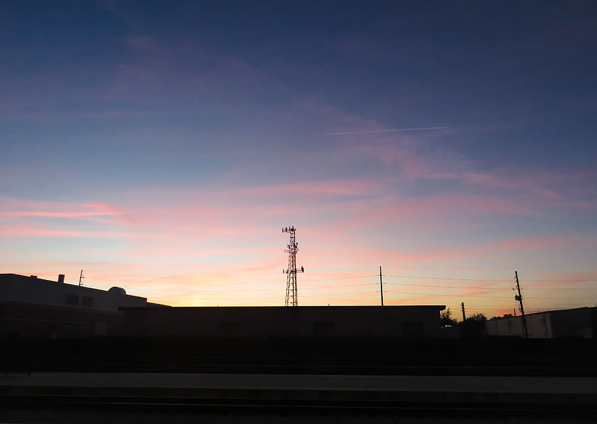 Silhouette of Cell Tower Against Pink and Blue Sunset Sky