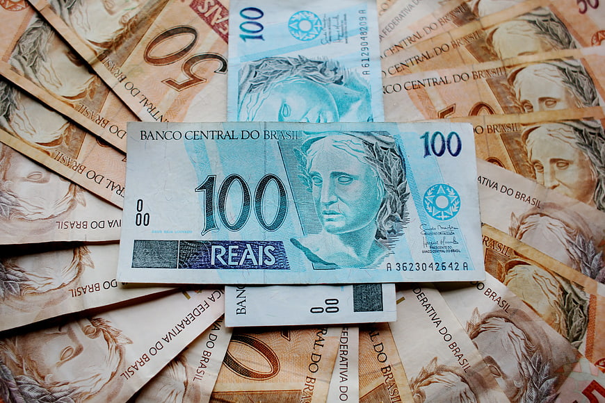 Brazilian Real banknotes pile with 100 Reais focus