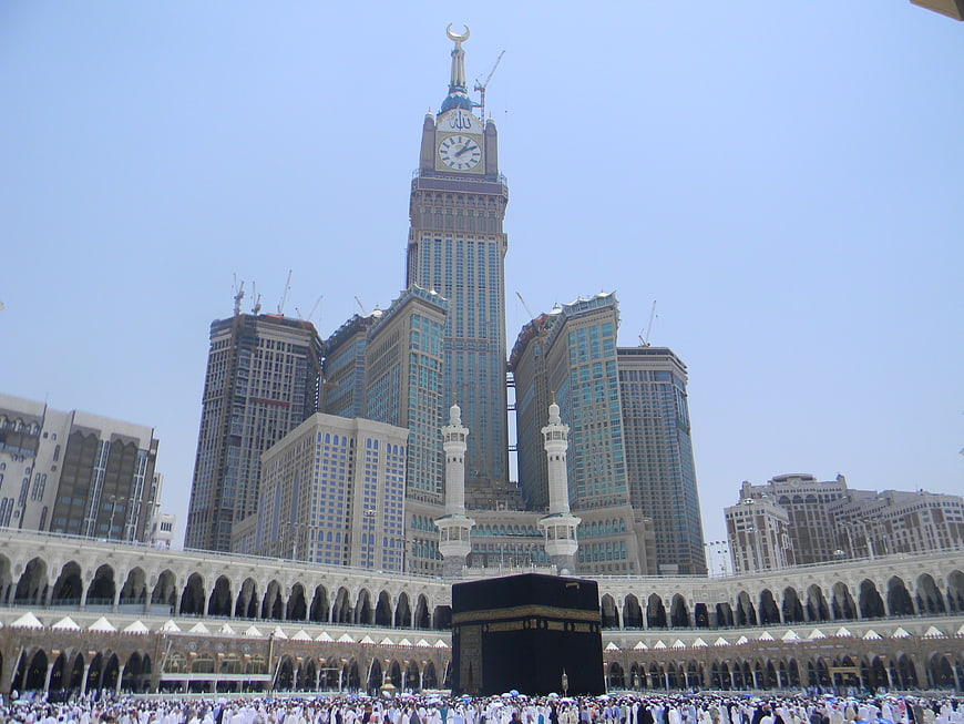 Kaaba in Mecca with Makkah Clock Tower and pilgrims