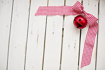 Red Christmas Bell with Gingham Ribbon on White Wood