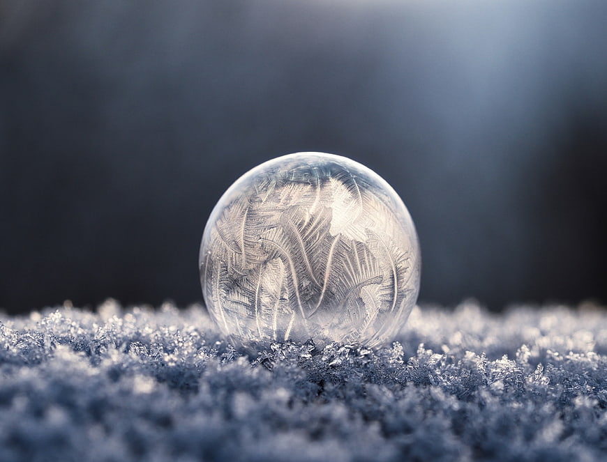 Frosted Ice Sphere on Snowy Surface