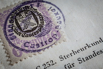Close-up of vintage German death certificate with purple wax seal