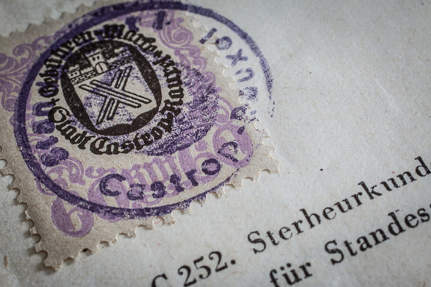 Close-up of vintage German death certificate with purple wax seal