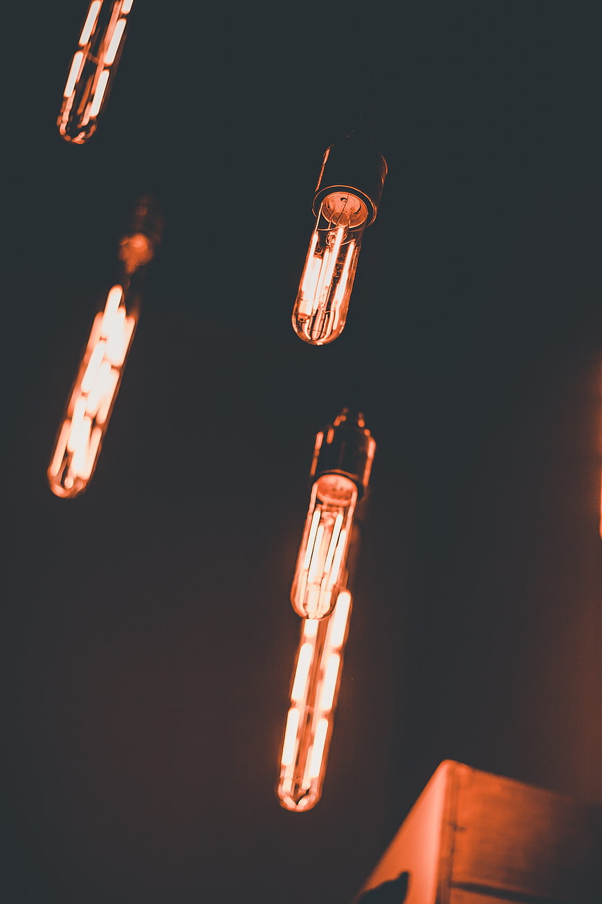 Vintage Filament Light Bulbs Hanging Against Dark Background