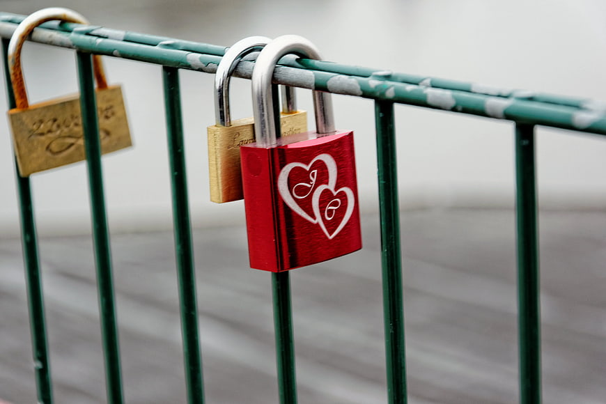 Red Love Padlock on Green Metal Fence