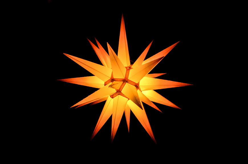 Glowing Orange Star Lantern on Black Background