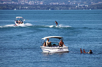 Water skiing and boating on a large blue lake