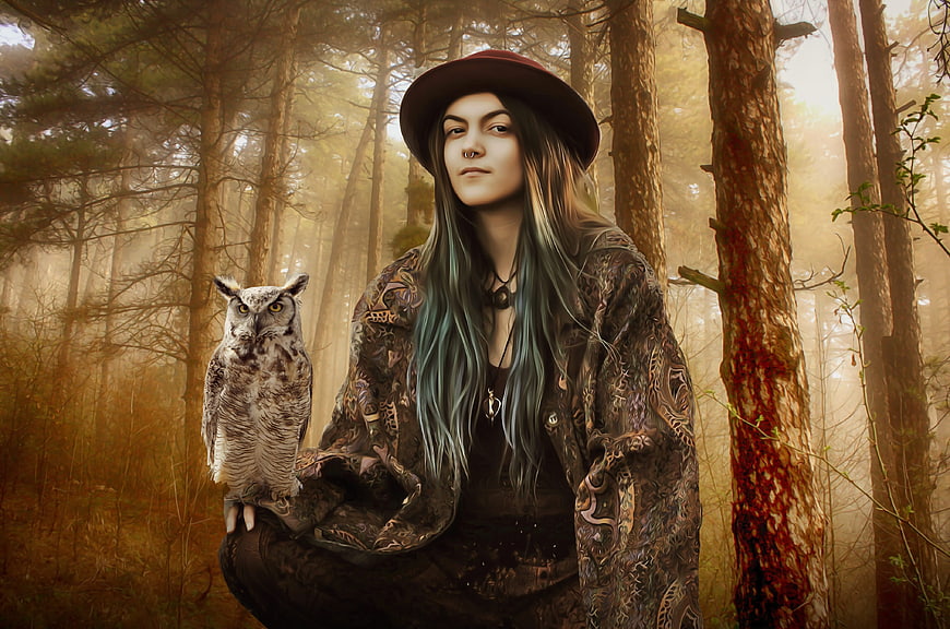 Fantasy portrait of woman with owl in misty forest