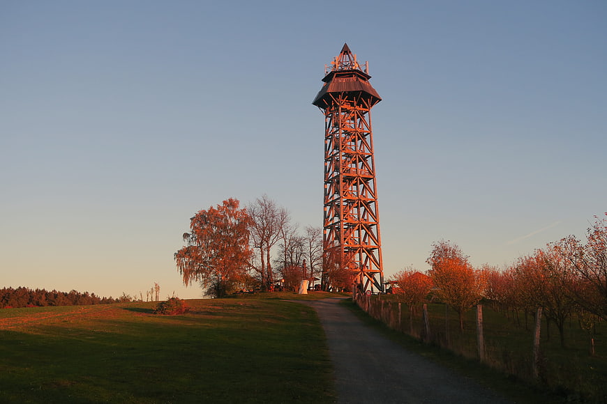 Wooden Lookout Tower in Autumn Landscape with Orchard