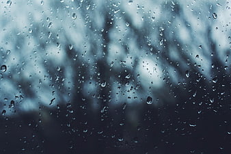 Raindrops on Window Glass with Blurred Background