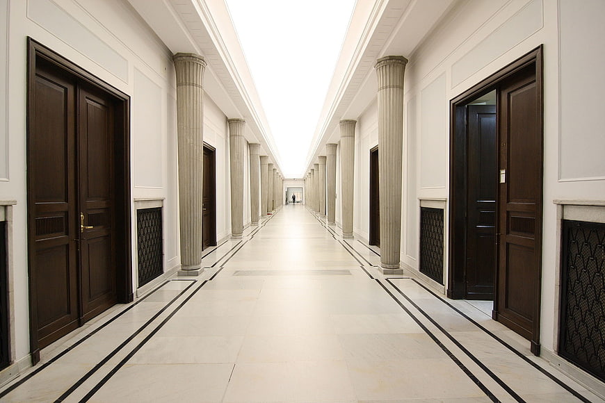 Grand Classical Hallway with Columns and Dark Wood Doors
