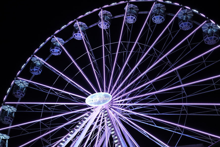 Illuminated Ferris Wheel at Night with Purple LED Lights