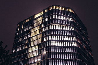 Modern Curved Office Building at Night