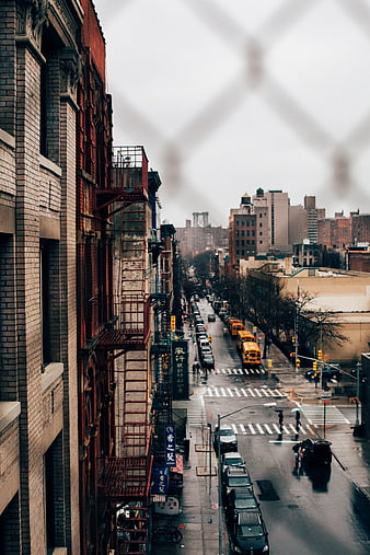 Rainy Urban Street View Through Window with Yellow School Bus