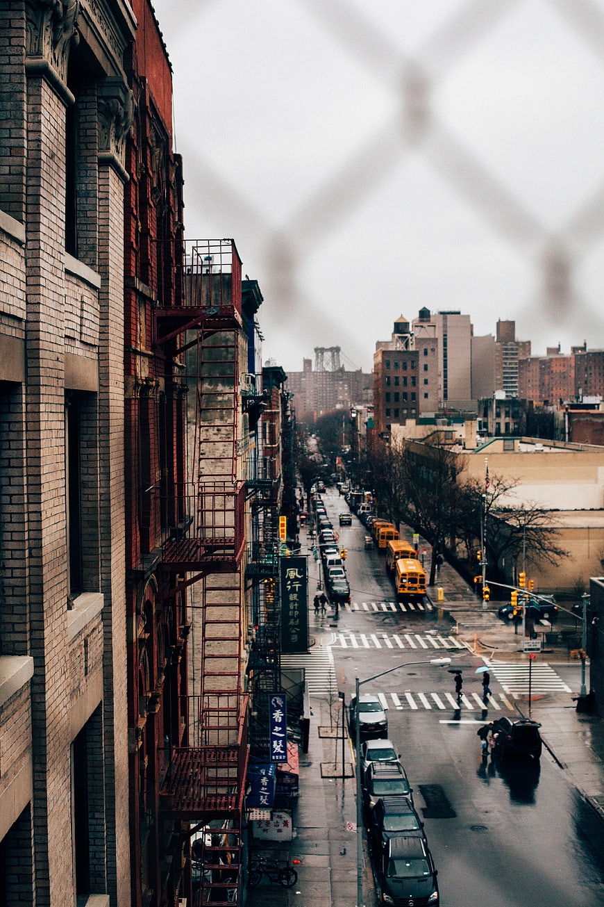 Rainy Urban Street View Through Window with Yellow School Bus