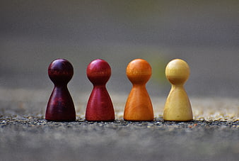 Four Colorful Wooden Game Pieces in a Row