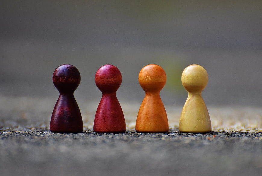 Four Colorful Wooden Game Pieces in a Row