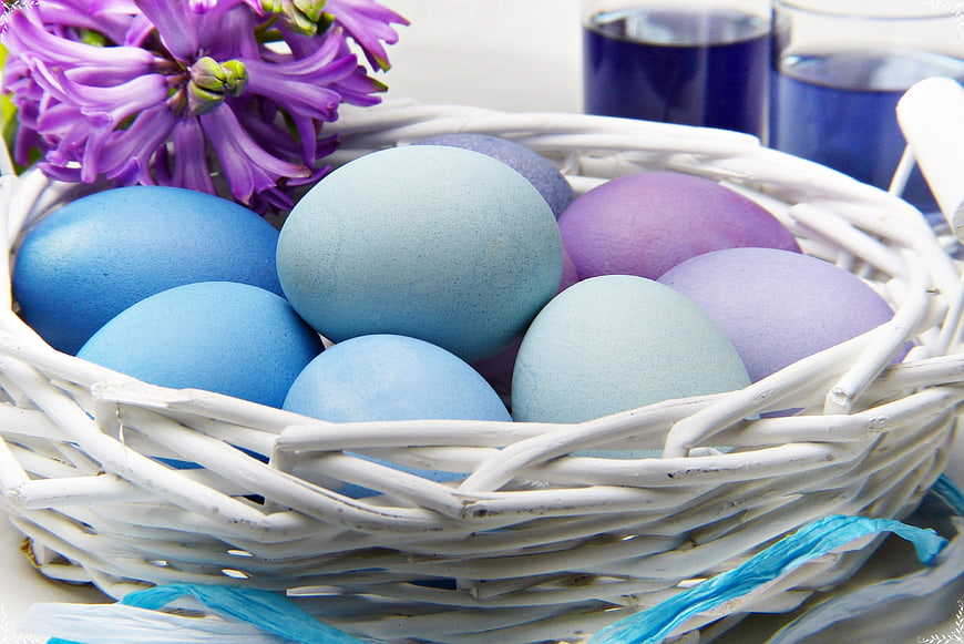 Pastel Easter Eggs in White Wicker Basket with Purple Hyacinth