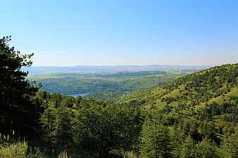 Panoramic View of Green Rolling Hills and Forested Valley