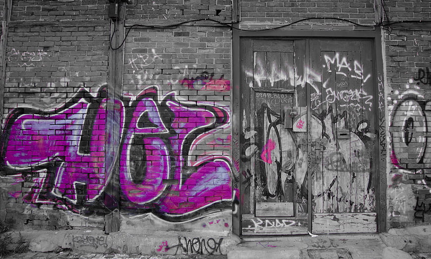 Vibrant Pink Graffiti on Grayscale Brick Wall