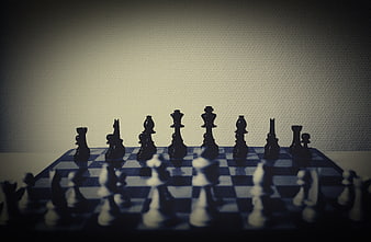 Dramatic Chess Pieces on Board with Bokeh Background
