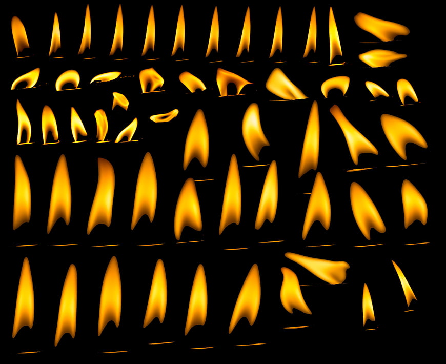 Grid of burning candle flames on black background