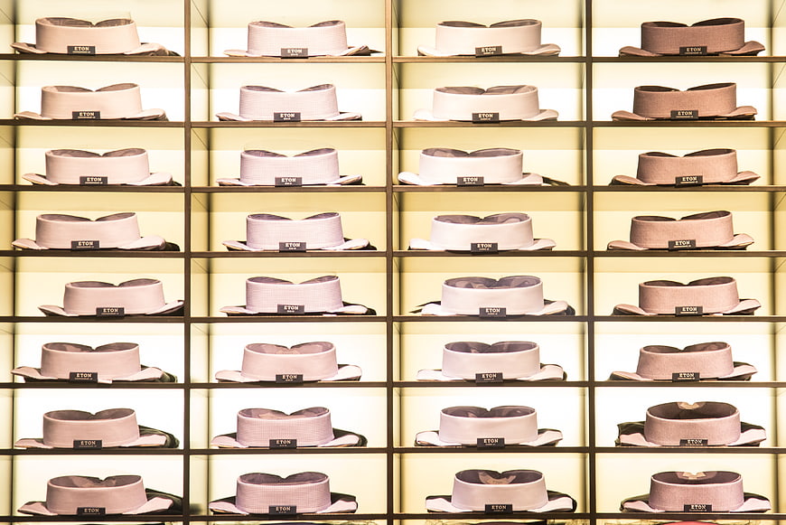 Grid of luxury Eton shirt collars on illuminated shelves