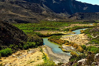 Winding River Through Arid Mountain Valley Landscape