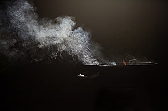 Dramatic Smoke Rising From Charcoal Grill Against Dark Background