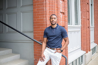 Confident Young Black Man in Navy Polo and White Pants