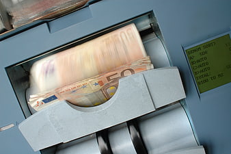 Euro banknotes being counted by a bill counting machine