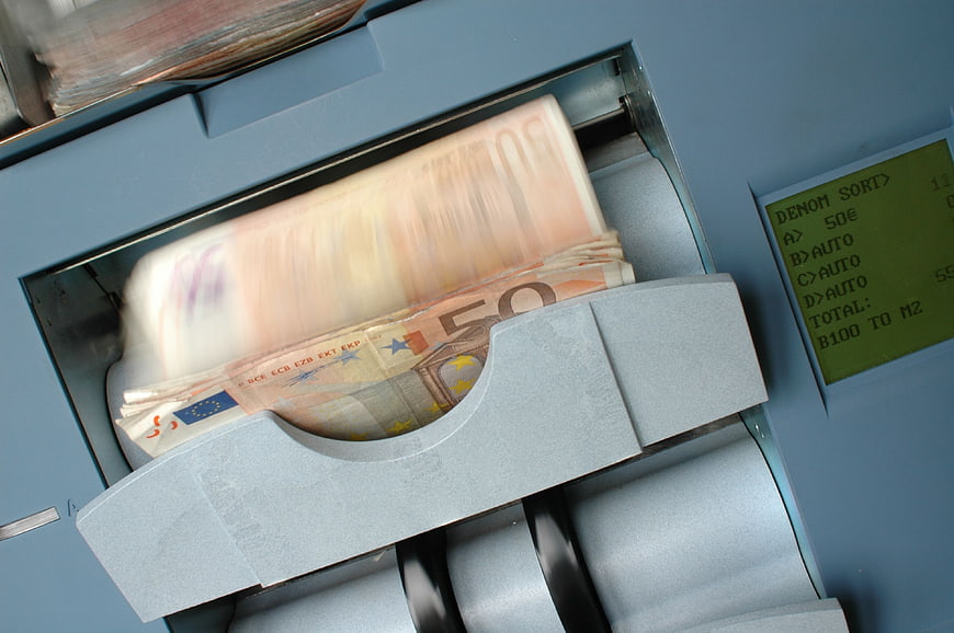 Euro banknotes being counted by a bill counting machine
