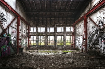 Abandoned Industrial Hall Interior With Graffiti And Broken Windows