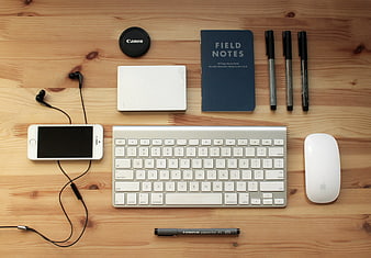 Flat lay of workspace essentials on wooden desk