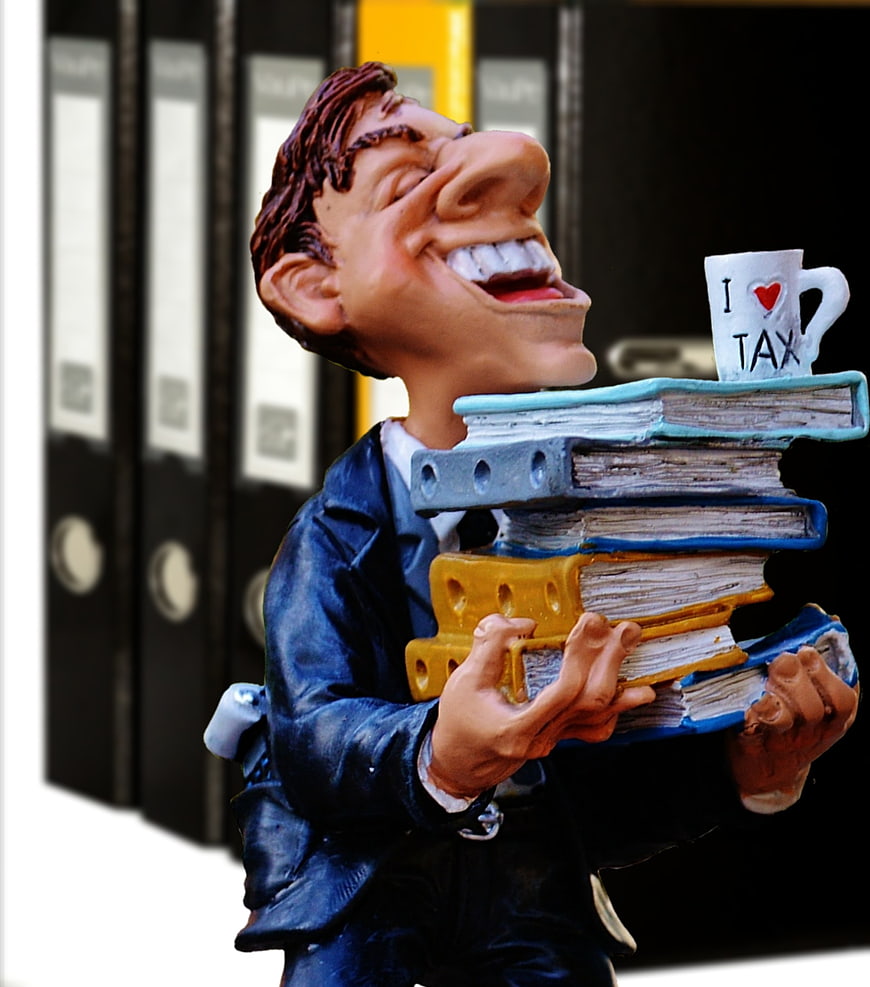 Caricature figurine of a man carrying stack of books and I Love Tax mug