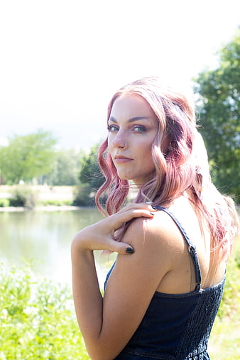 Portrait of woman with pink hair in park