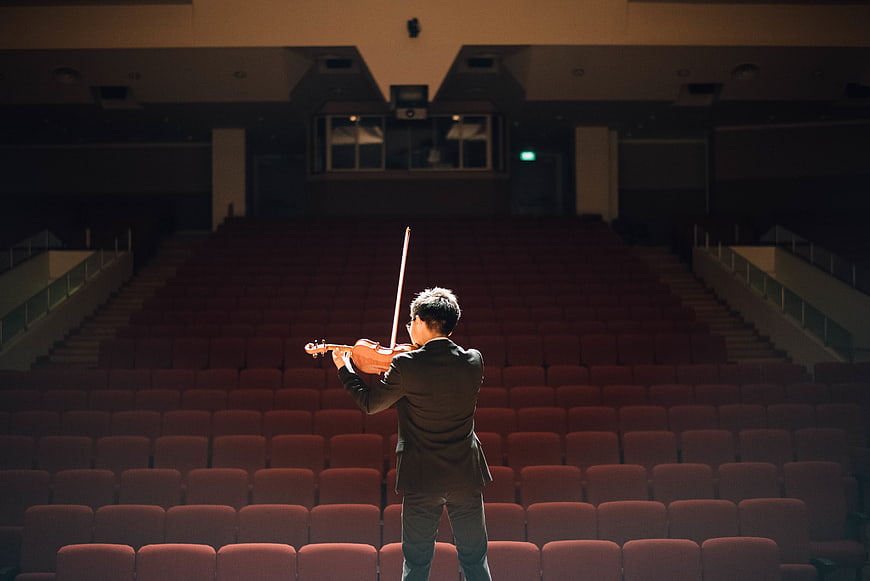 Violinist Performing in Empty Auditorium