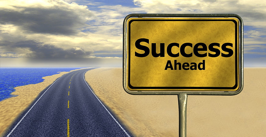 Golden Success Ahead Sign on Desert Road