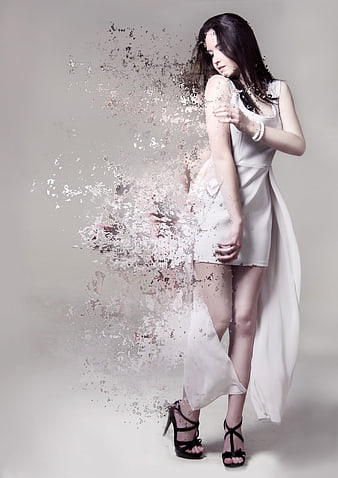 Young woman in white dress with digital dissolve effect